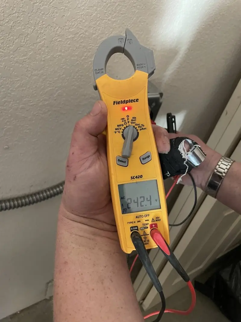 Voltage testing with clamp meter during Recessed Lighting Installation in Enon